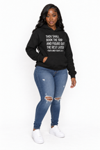 AI styling mockup: Khadijah in black Faith and Flights hoodie with distressed jeans, angled view